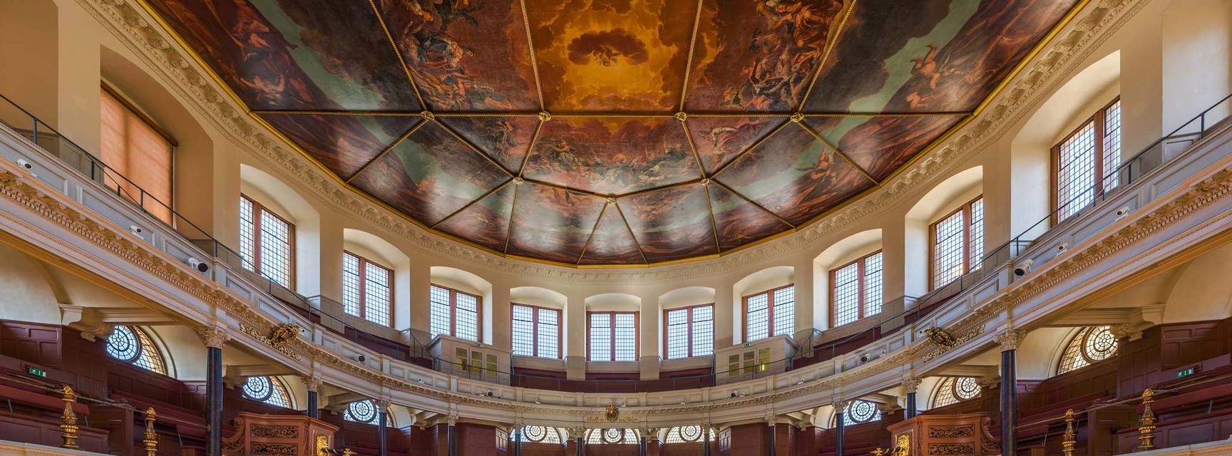 Photo of the inside of the Sheldonian Theatre with full view of the painted ceiling