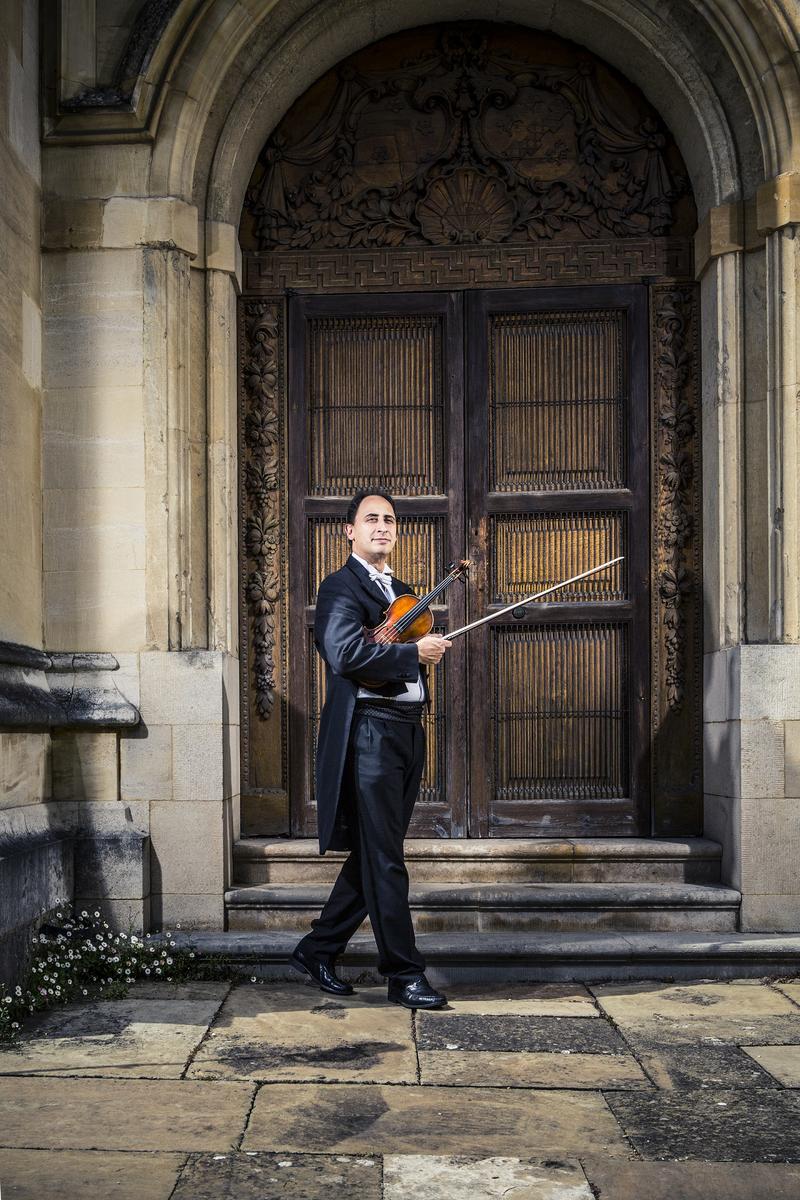 Carmine Lauri in concert dress with a violin