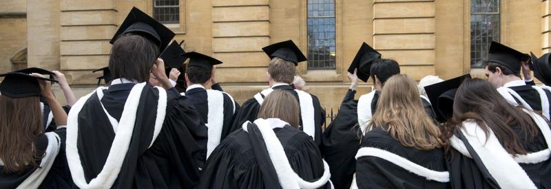 Photo of students in caps and gowns entering the Sheldonian Theatre for their degree ceremony 